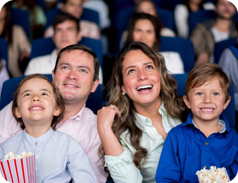Happy family at the cinema watching a movie