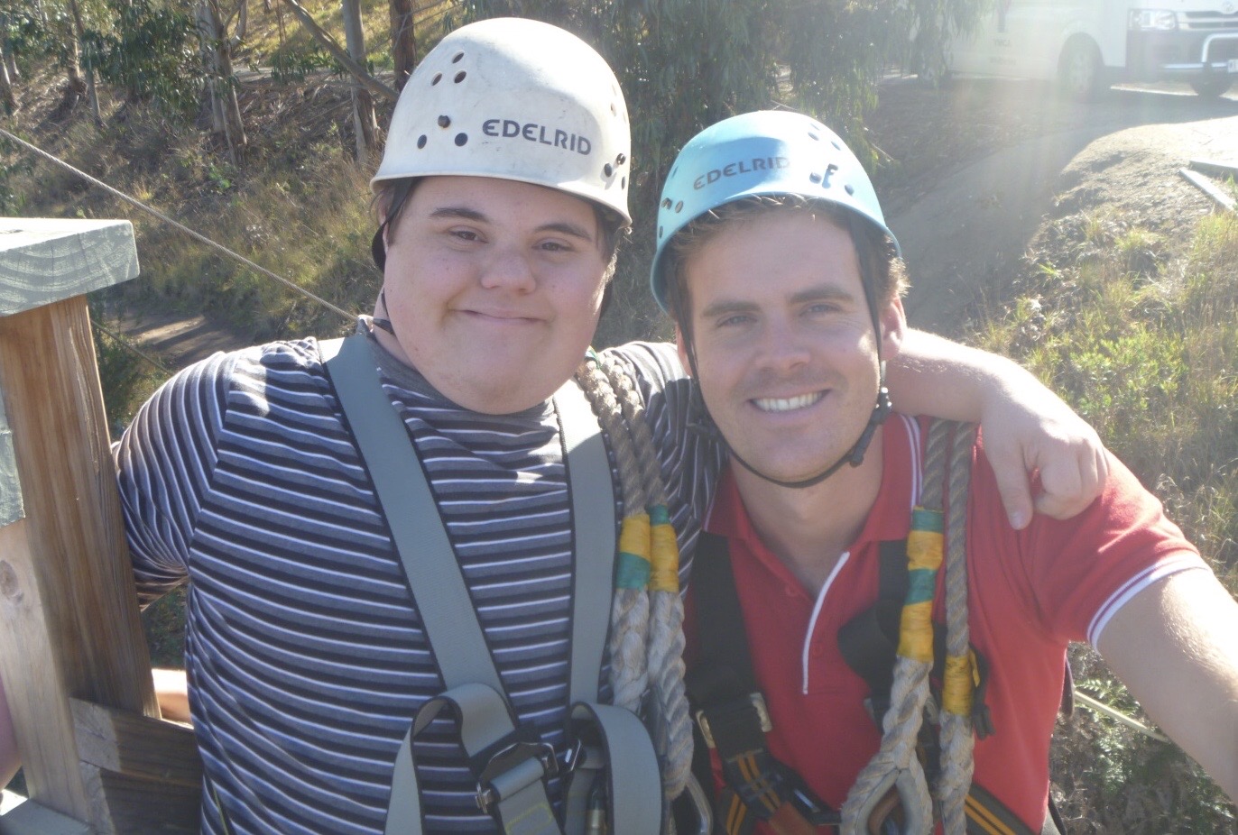 Two smiling men in climbing gear