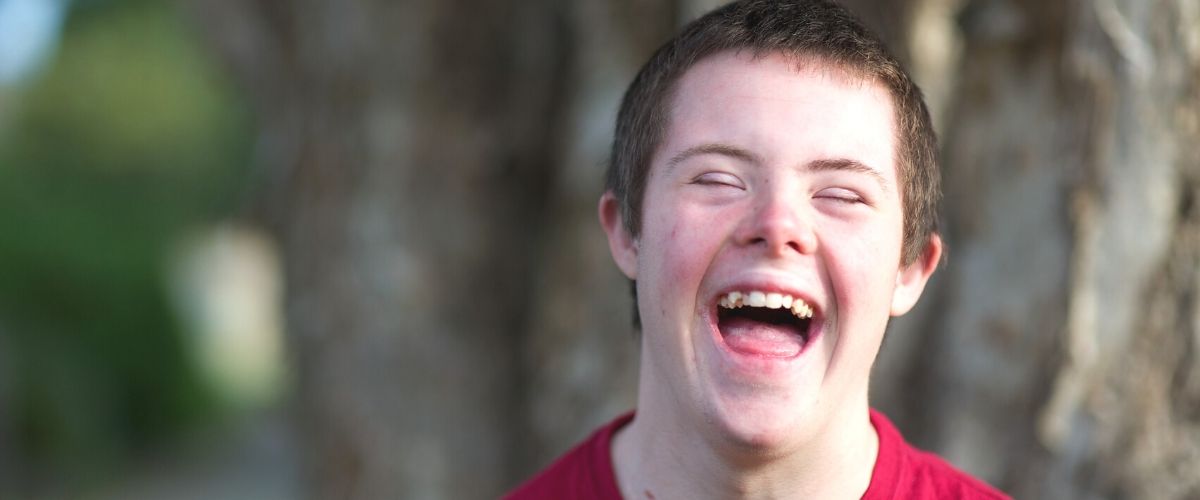 Boy outdoors, laughing
