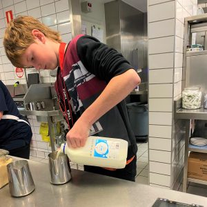 Young person preparing to make coffee in the cafe